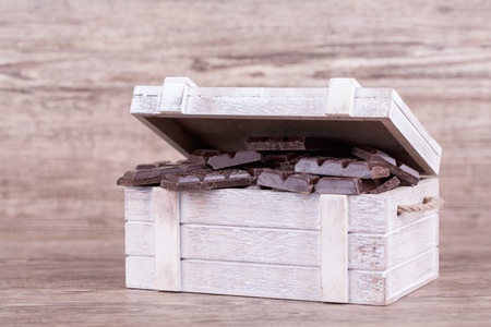 Chocolate with nuts on a wooden background