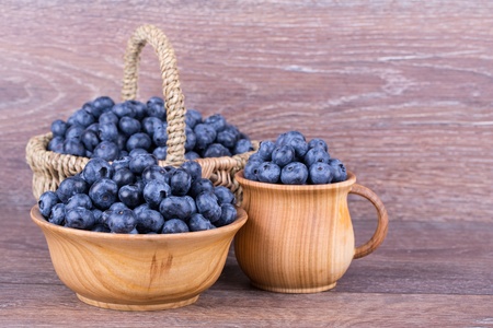 blueberries in wooden bowl on white backgroundの写真素材