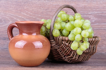 grapes in a basket on a wooden backgroundの写真素材