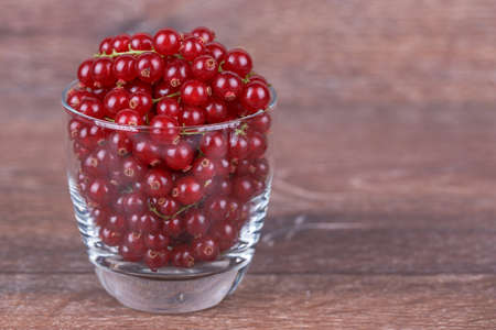 berries in a glass on a wooden background