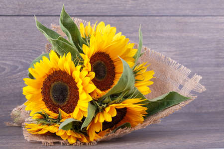 Bouquet of sunflowers on a wooden background.の写真素材