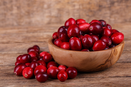 Fresh, ripe, red cranberries on a wooden backgroundの写真素材