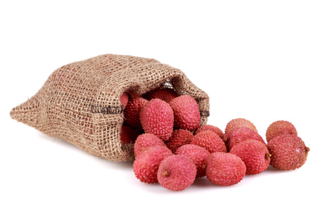 Fresh, ripe, red lychee in bag on white backgroundの写真素材