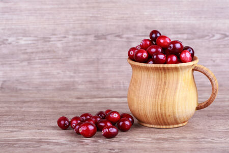 Fresh, ripe, red cranberries on a wooden backgroundの写真素材