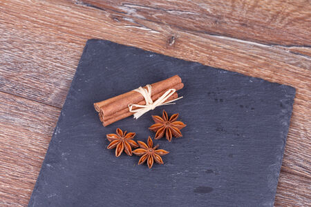 Dried Anise and Cinnamon on Black Tableの写真素材