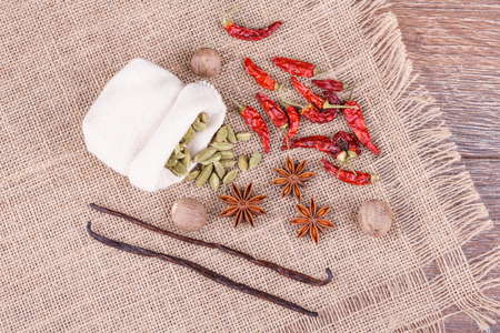 Various spices and herbs on wooden backgroundの写真素材