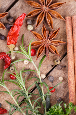 Various spices and herbs on wooden backgroundの写真素材