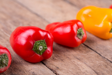 fresh red, yellow paprika on wooden backgroundの写真素材