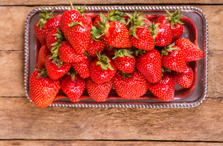 sweet, fresh strawberries on a wooden  backgroundの写真素材