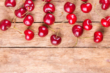 sweet, fresh cherries on a wooden background