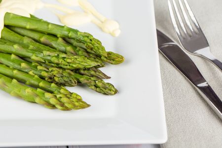 Fresh, ripe, green  asparagus on wooden background.の写真素材