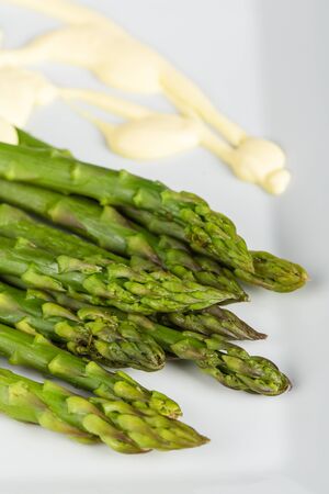 Fresh, ripe, green  asparagus on wooden background.の写真素材