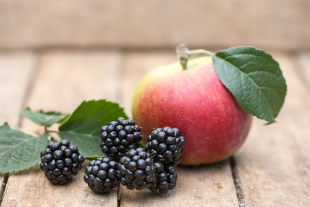 apple and blackberries on a wooden backgroundの写真素材