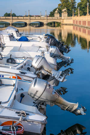 Parked motor boats outdoors on a summer day.