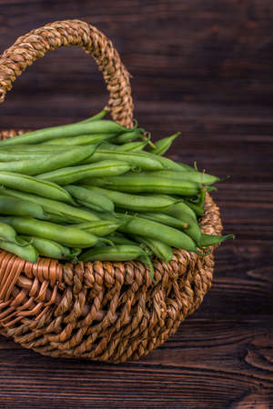 Fresh green beans on wooden table on rustic wooden background.の写真素材