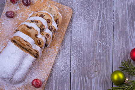 Christmas marzipan stollen cake with icing sugar, marzipan and raisins.の写真素材