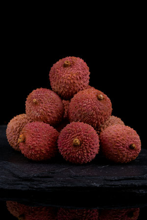 Fresh lychee fruit on black background.の写真素材