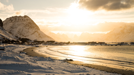 Beautiful sunset in a snow covered beach in Lofoten Island, Norwayの写真素材
