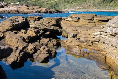 Crystal clear water in a natural rocky pool in Buziosの写真素材