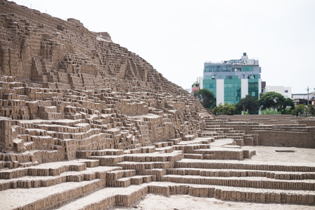 Contrast of Inca Ruins and modern buildings in Lima, Peruの写真素材