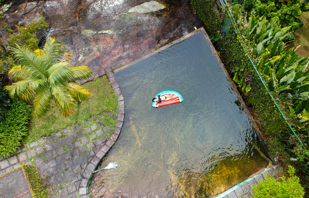 Girl floating in a watermelon buoy in Teresopolis, Rio de Janeiro, Brazilの写真素材