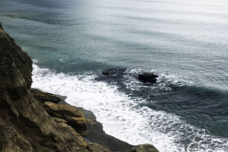 sea wave washes beach of pebbles sea occupies a large area of the picture is in the corner of coast top viewの写真素材