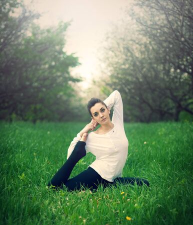beautiful girl is engaged in yoga in the forestの写真素材