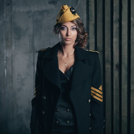portrait of girl in a sexy black aviator uniform with hat