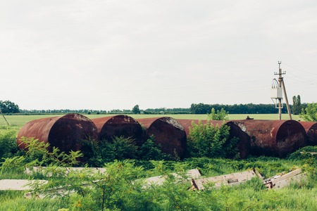 An old rusty automobile tanker for gasoline is thrown in old technopark of Chernobyl after accident at nuclear power plant. Apocalypse, Pripyat. Radiation. Abandoned rusty vehicle technologyの写真素材