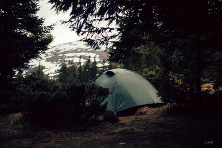 Camping tent in the forrest and mountainsの写真素材