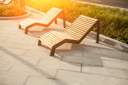 Sun loungers on the public park in the Moscow street. Bench in the townの写真素材