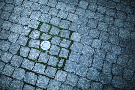 Granite gray cobblestone pavement abstract background with ground lampの写真素材