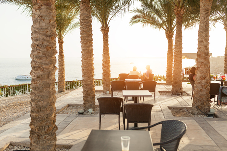 Outdoor luxury cafe restaurant in the tropical country with palm tree Summerのeditorial素材