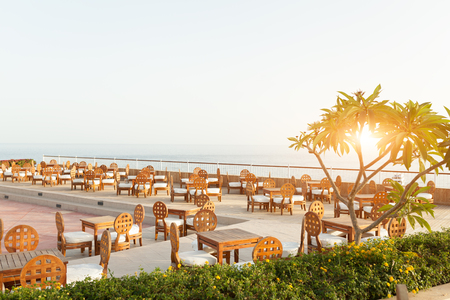 Outdoor luxury cafe restaurant in the tropical country with palm tree Summerのeditorial素材