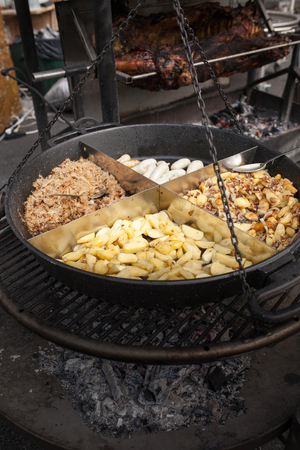 street food festival. grilled meat and vegetables mushrooms. roasting sausages on big grill, open kitchen, food court. cooking smoked juicy ribs potatoes bbq. summer picnicの写真素材