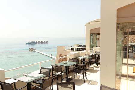 Outdoor luxury cafe restaurant in the tropical country with palm tree Summerのeditorial素材