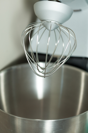 Top of modern mixer with steel whisk close upの写真素材