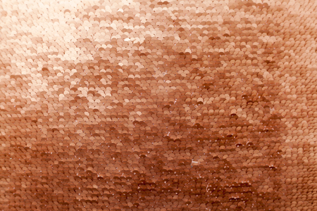 Sequins close-up macro. Abstract background with gold sequins color on the fabric. Texture scales of round sequins with color transition .の写真素材