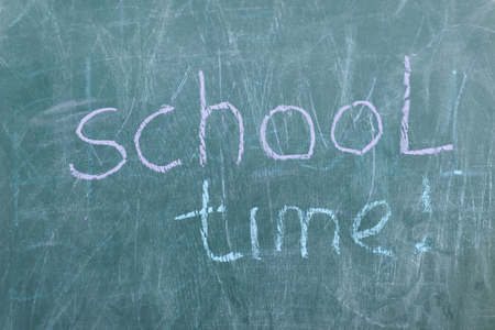 Green Chalkboard close up with wooden frame and the text school timeの写真素材