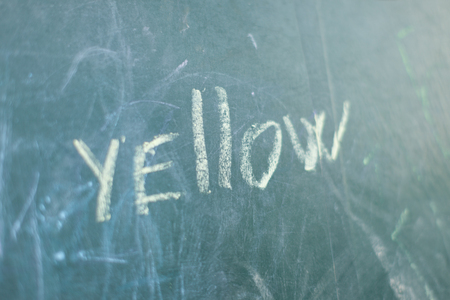 Green Chalkboard close up with wooden frame and the text Yellowの写真素材