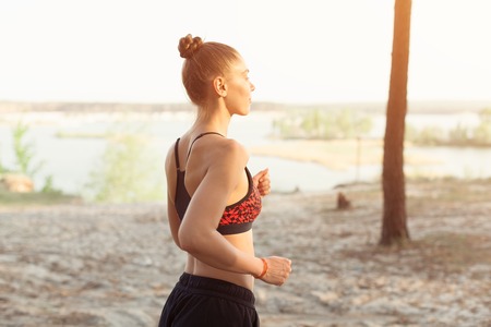 healthy lifestyle brunet fitness sporty woman runner running in pine morning forest Healthy lifestyle sport conceptの写真素材