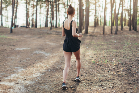 healthy lifestyle brunet fitness sporty woman runner running in pine morning forest Healthy lifestyle sport conceptの写真素材
