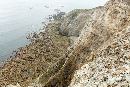Summer Atlantic rocky coast view Big stony rockfall on precipice shore and ocean surf waves. Crozon, France View near the Memorial naval aviation Cape of the Goat, May 2018の写真素材