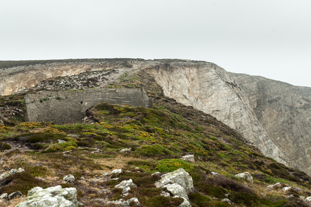 Summer Atlantic rocky coast view Big stony rockfall on precipice shore and ocean surf waves. Crozon, France View near the Memorial naval aviation Cape of the Goat, May 2018の写真素材