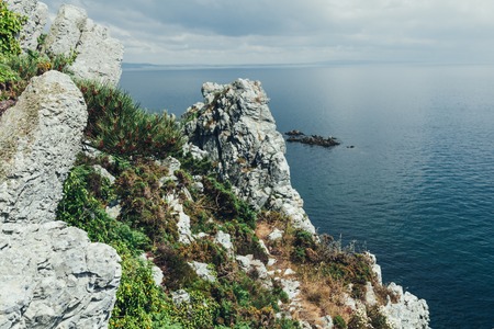 Sharp cliffs hang over the ocean, Dramatic marine background.の写真素材