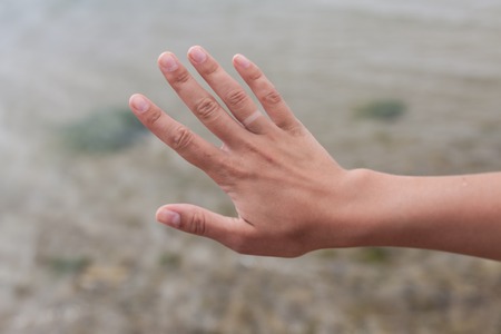 Hand without engagement ring with suntan. The girl took off the wedding ring on vacation that no one knew that she was married.の写真素材