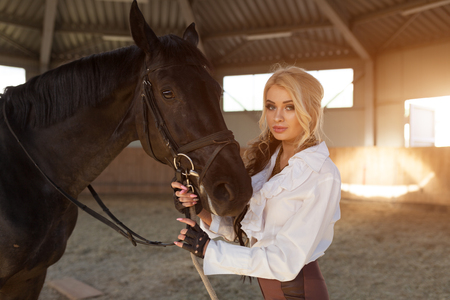 Portrait of a girl and horse fase to faceの写真素材