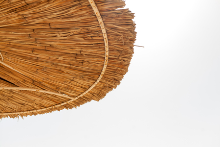 Straw Beach umbrella on sky white background close upの写真素材