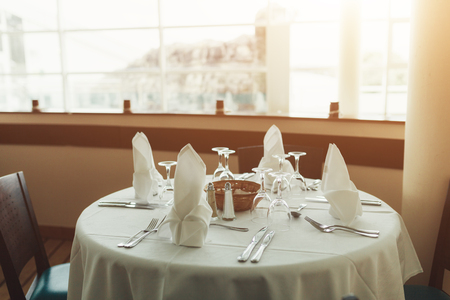 Beautiful table served with glassware and cultery, prepared for festive event. Special occasion celebrted in luxury restaurant or cafe. Table setting concept. Wedding table.の写真素材