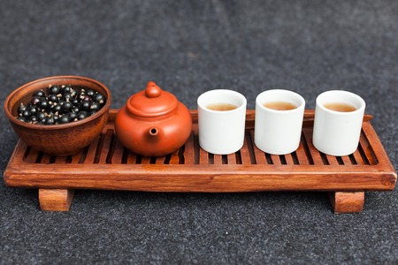 Traditional Chinese tea ceremony with black currant, fruit tea and healthy food. Photo without people. Summer natural vitamins and berries.の写真素材
